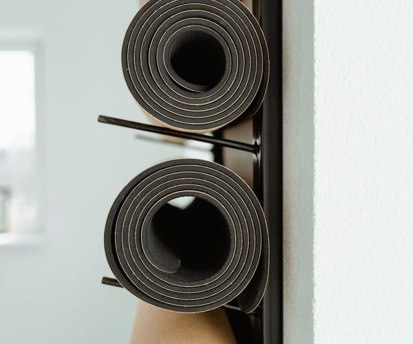 Interior of a calm and minimalist yoga studio with mats on the floor.